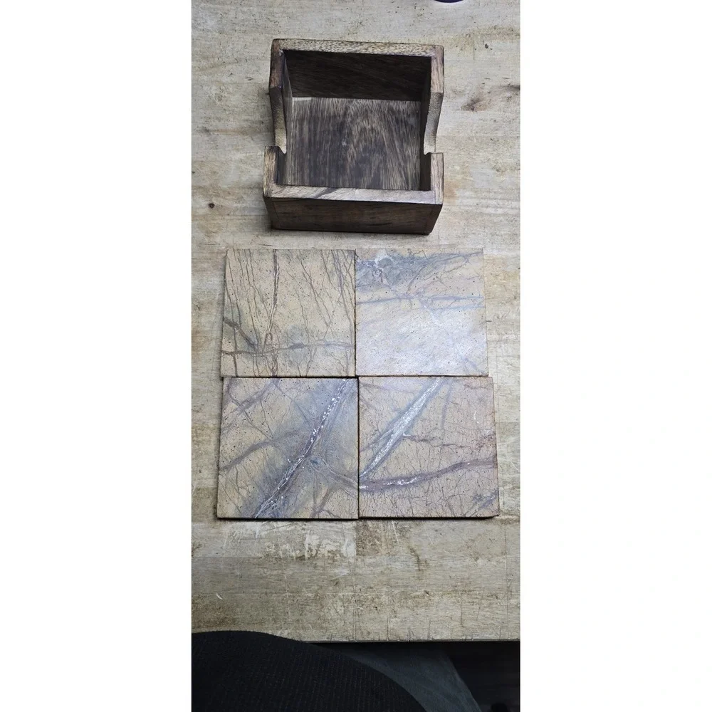 square marble coaster set holder in a wooden base.